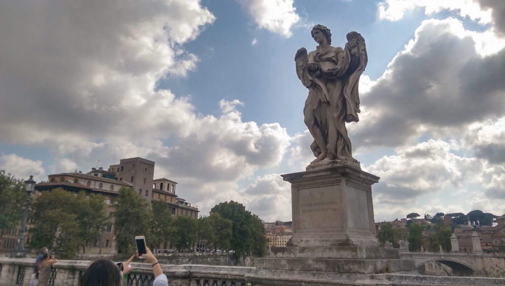 Sculpture admired by tourists in front of Castel Sant'Angelo in Rome.